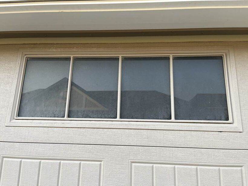 Dusty garage transom window before cleaning