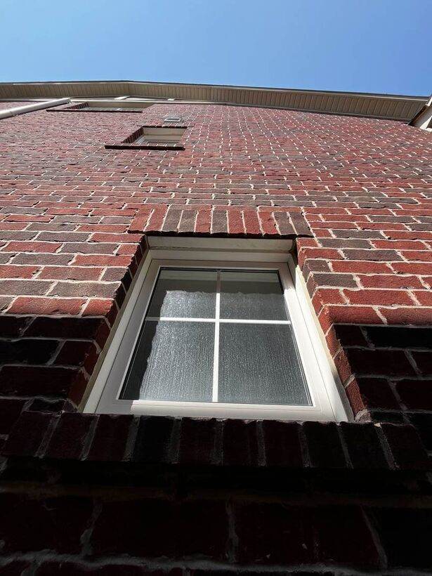 Exterior window on brick house before cleaning