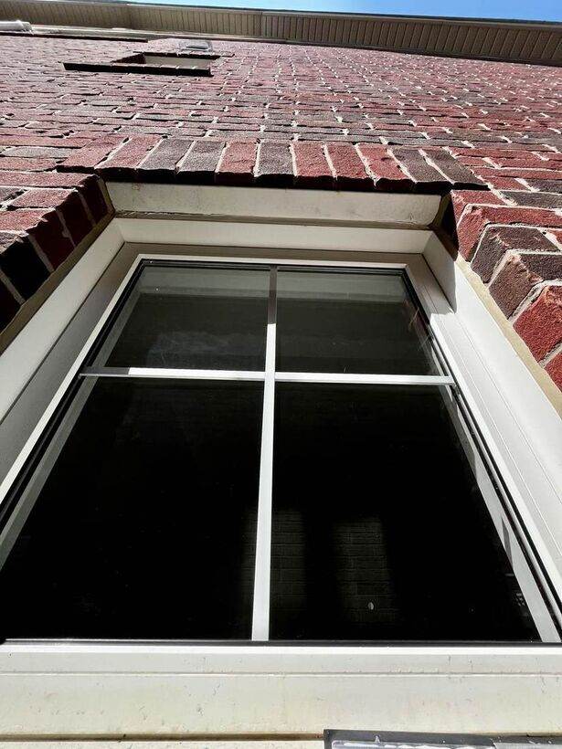 Clean exterior window on brick house after cleaning