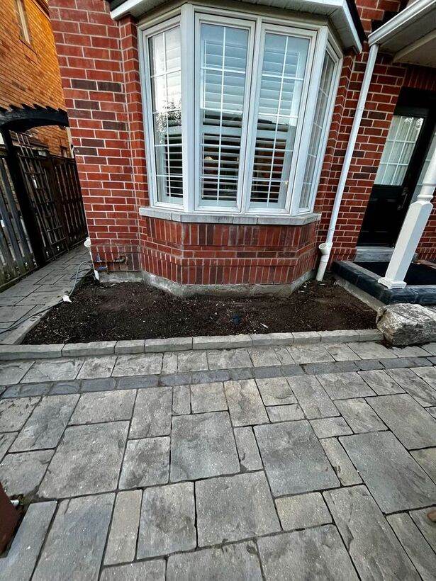 Cleared soil bed at bay window after landscaping